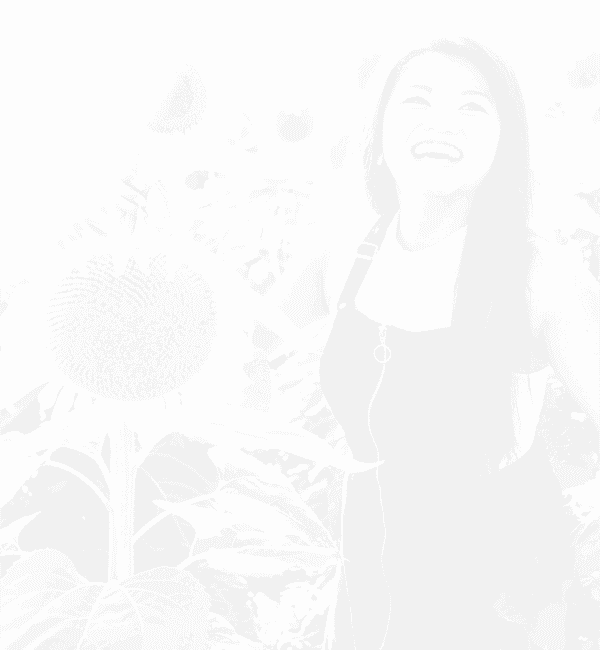 Smiling girl near sunflowers